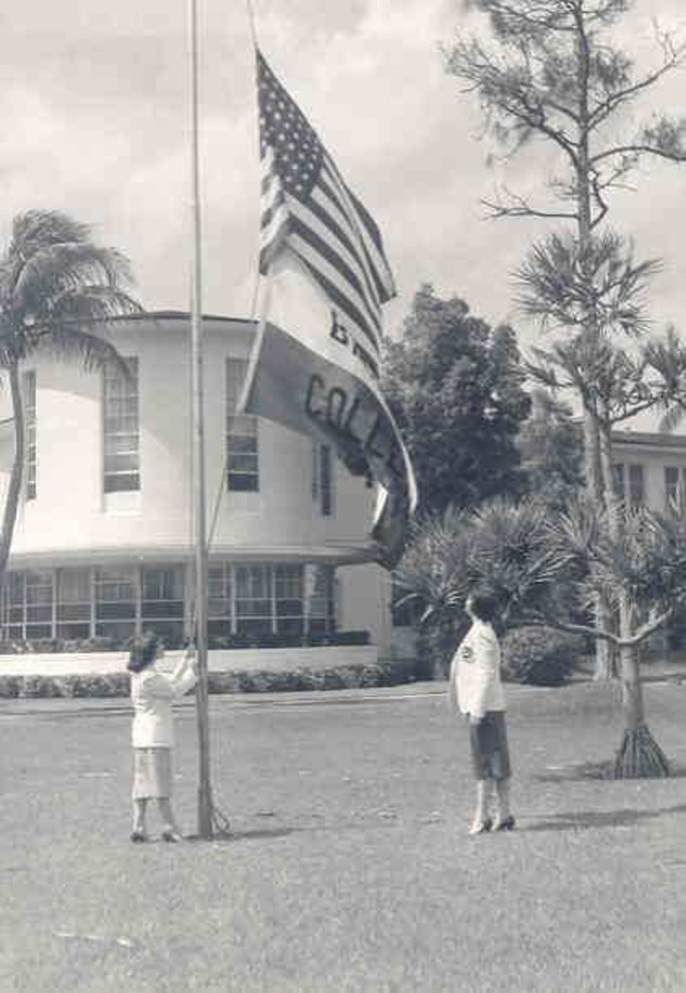 Students raise the American and Barry College flags